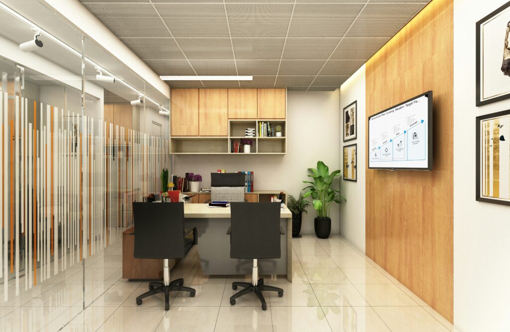 Modern office space for lease near me featuring a professional desk setup, ergonomic chairs, shelving, plants, and a wall-mounted display for small business productivity.