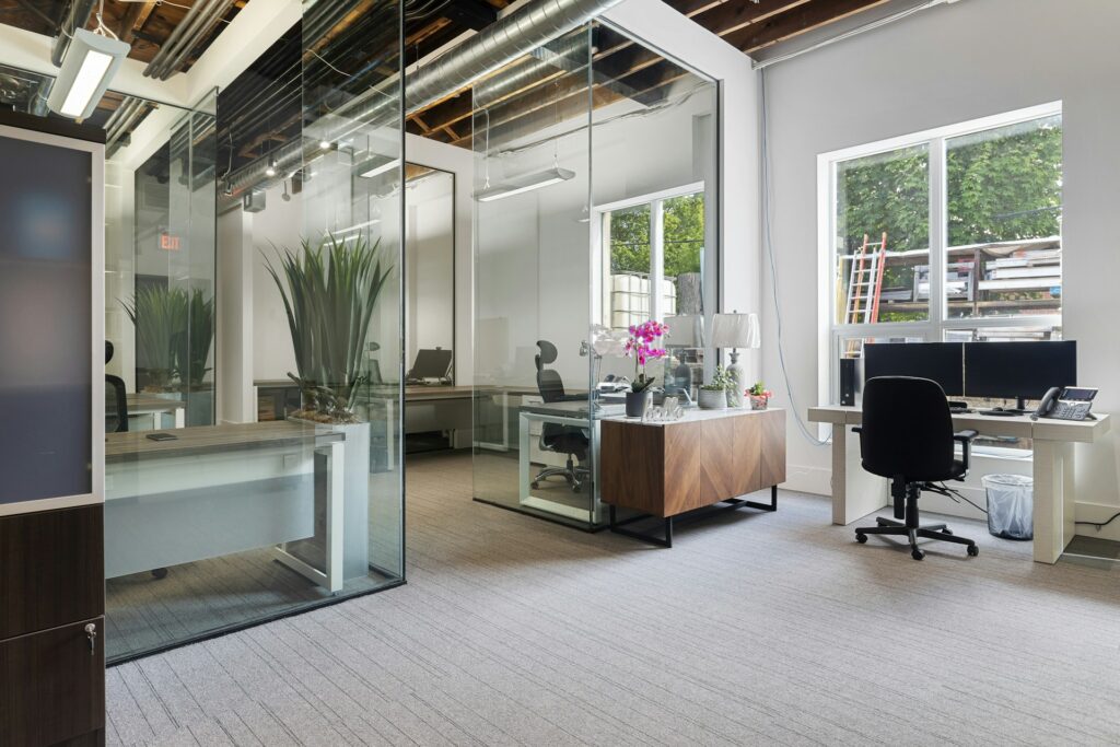 Modern office space for rent featuring a clean desk setup and chairs in a bright, well-designed room promoting productivity.