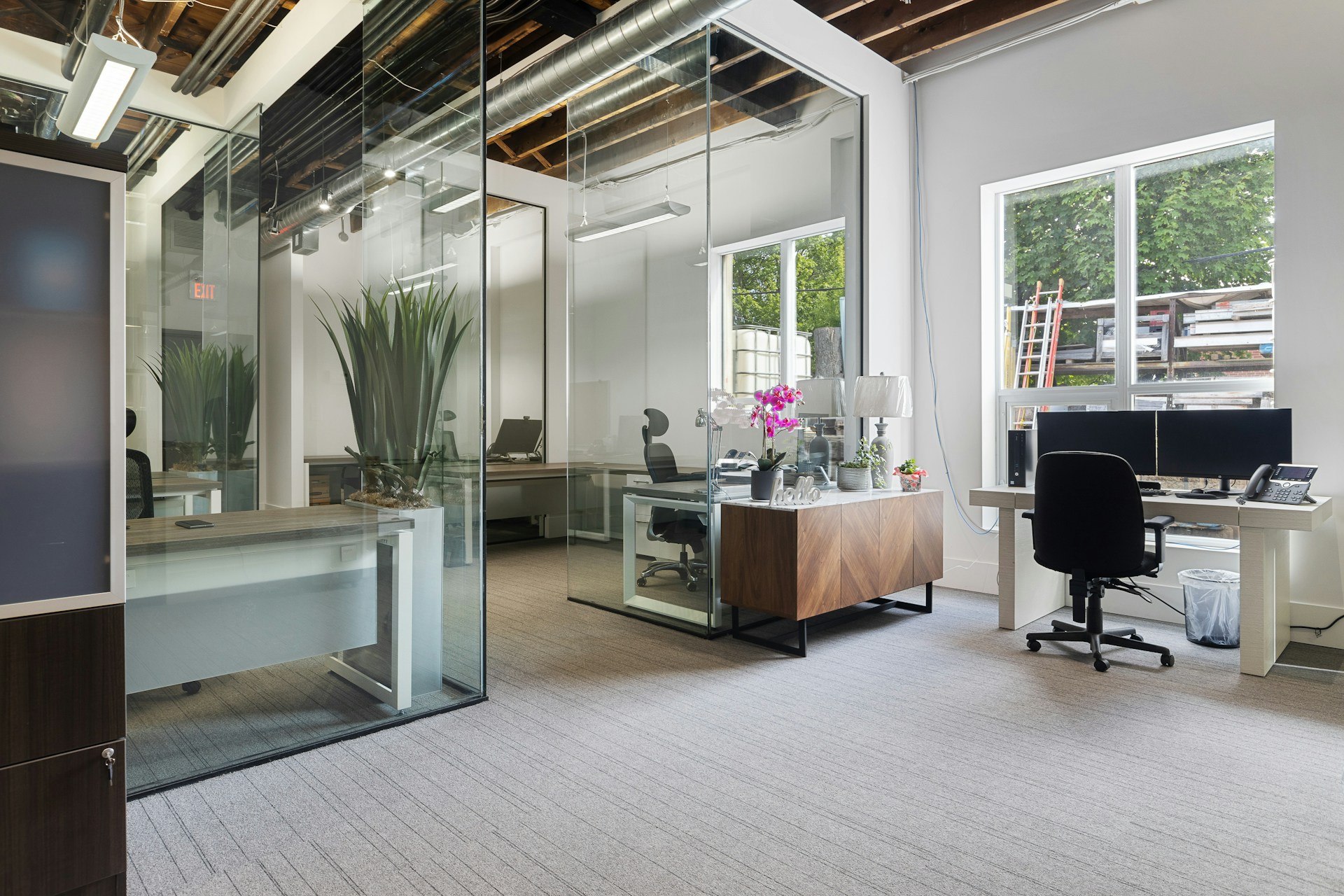 Modern office space for rent featuring a clean desk setup and chairs in a bright, well-designed room promoting productivity.