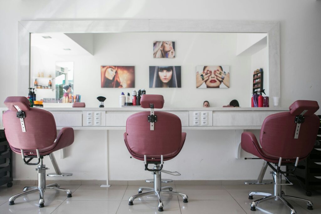 Modern beauty salon interior with styling chairs, mirrors, and bright lighting, ideal setup for professionals seeking a beauty salon space for lease.