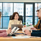 Business team meeting discussing financial reports and charts in modern office