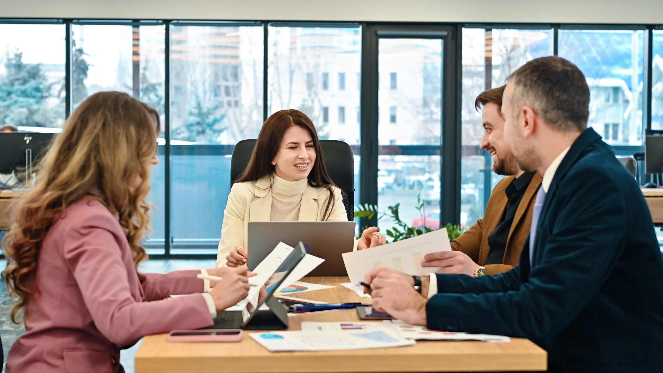 Business team meeting discussing financial reports and charts in modern office