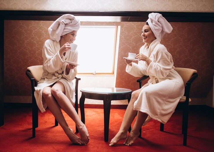 luxury restaurant interior with two women relaxing and drinking coffee